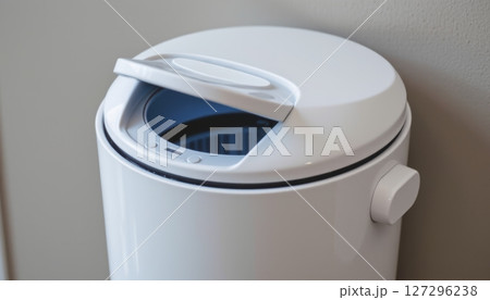 Modern white trash can with a lid and control panel. 127296238