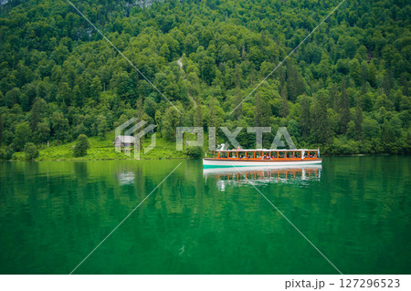 Konigssee Lake in Bavaria Germany with Church by the Lake White Boat Forested Mountain and Beautiful Sunny Trekking in Berchtesgaden German Alps. High quality photo 127296523