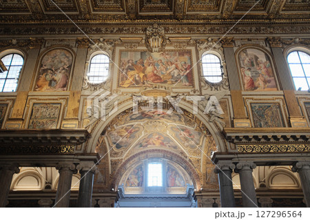 Detailed arch fresco and wall painting inside Basilica of Saint Mary Major Rome with religious themes and ornate baroque framing in golden tones. High quality photo 127296564