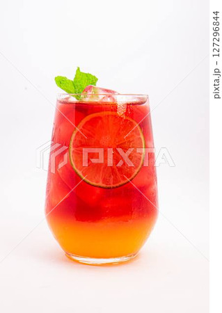 vibrant red citrus cocktail with blood orange slice and fresh mint served in clear glass over ice on white background. High quality photo vibrant red citrus cocktail with blood orange slice and fresh mint served in clear glass over ice on white background. High quality photo 127296844