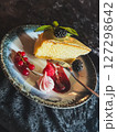 Piece of cheesecake with fresh berries and mint on dark background 127298642