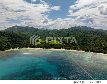 Tropical Beach with ocean waves and turquoise sea water with sun reflection. El Nido, Palawan. Philippines. Tropical Beach with ocean waves and turquoise sea water with sun reflection. El Nido, Palawan. Philippines. 127298935