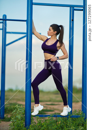 sporty girl poses gracefully on sports ground with vibrant sea backdrop during sunset She exudes strength and confidence her athletic outfit while engaging with environment sporty girl poses gracefully on sports ground with vibrant sea backdrop during sunset She exudes strength and confidence her athletic outfit while engaging with environment 127299065