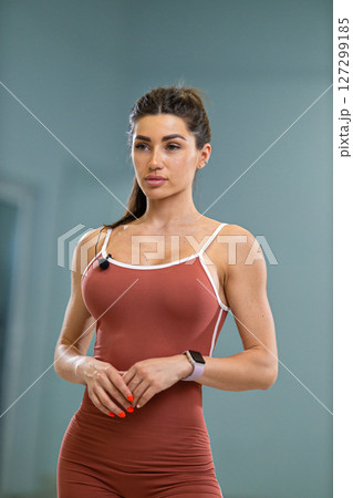Sporty girl announcer stands confidently in a fitness studio wearing athletic attire She is poised to share health and fitness insights, ready to engage the audience with her energy Sporty girl announcer stands confidently in a fitness studio wearing athletic attire She is poised to share health and fitness insights, ready to engage the audience with her energy 127299185