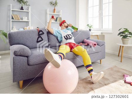 Funny Lazy Man In Retro Sportswear Drinking Alcohol During Home Gym Workout 127302601
