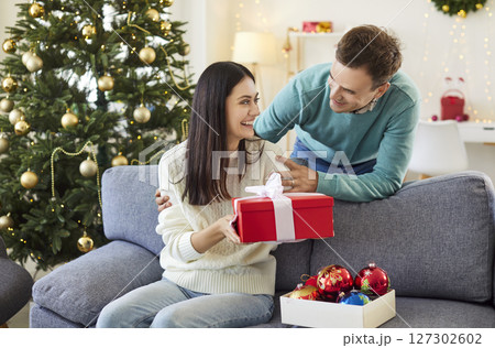Married Couple Celebrating Christmas Or New Year With Gifts At Home 127302602
