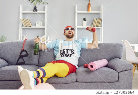 Lazy Man Drinking Alcohol On Couch In Funny Outfit During Home Workout 127302664