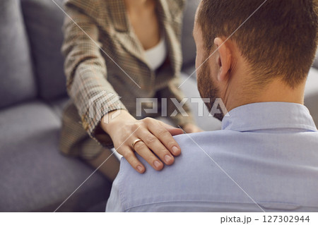 Hand on shoulder support kind gesture, woman caring touching man expressing empathy 127302944