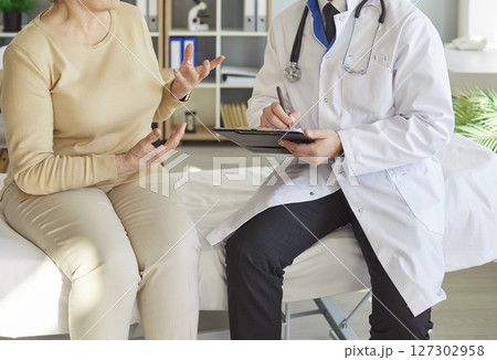 Senior woman patient having consultation with doctor in medical clinic during exam. Senior woman patient having consultation with doctor in medical clinic during exam. 127302958