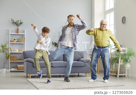 Happy multi generation family of men having fun in living room, dancing and enjoying time together. 127303020