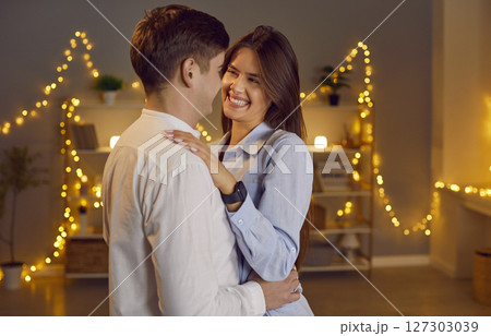 Happy Married Couple Embracing During Valentine's Day Celebration At Home 127303039