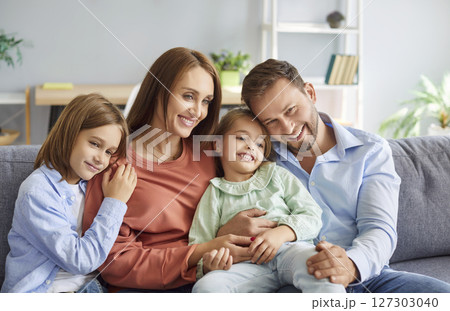Happy Parents And Children Embracing On The Couch At Home Happy Parents And Children Embracing On The Couch At Home 127303040