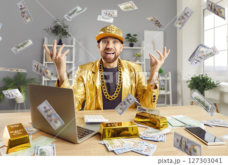 Funny man sitting at desk throwing dollar bills making money rain celebrating success Funny man sitting at desk throwing dollar bills making money rain celebrating success 127303041
