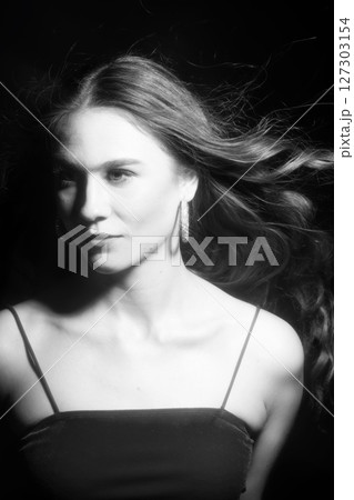 Beautiful woman with long blowing wavy hair studio portrait Beautiful woman with long blowing wavy hair studio portrait 127303154