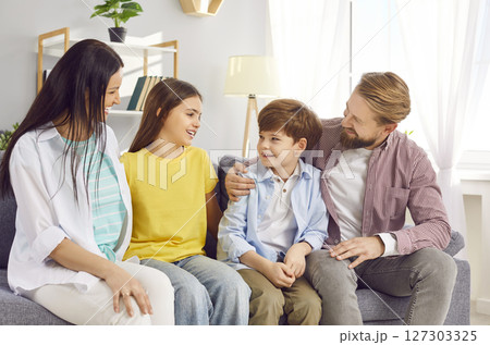 Happy Family With Children Sitting On Sofa At Home Happy Family With Children Sitting On Sofa At Home 127303325