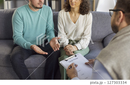 Young family couple visiting psychologist and discussing relationship issues during therapy. 127303334