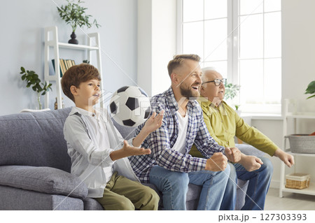 Grandfather, Son, And Father Watching Football Match On Tv At Home Grandfather, Son, And Father Watching Football Match On Tv At Home 127303393