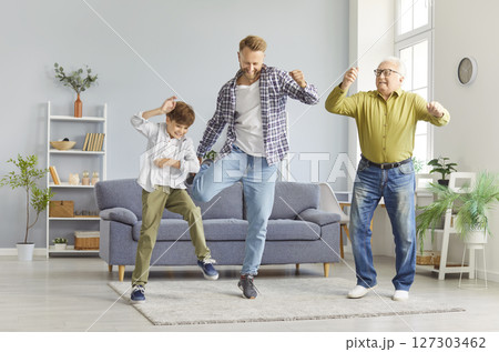 Grandfather, Father, And Son Dancing To Music And Having Fun At Home Together Grandfather, Father, And Son Dancing To Music And Having Fun At Home Together 127303462