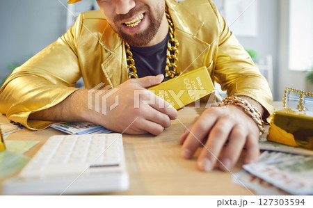 Rich Smiling Man In Golden Suit Holding Gold Bar Rich Smiling Man In Golden Suit Holding Gold Bar 127303594
