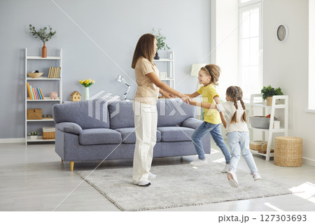 Playful funny dance of active family, mother parent, babysitter, cute small children daughter, son Playful funny dance of active family, mother parent, babysitter, cute small children daughter, son 127303693