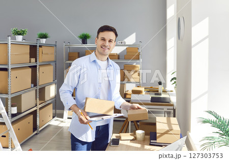 Portrait Of Happy Businessman Working In Warehouse Or Postal Office Portrait Of Happy Businessman Working In Warehouse Or Postal Office 127303753