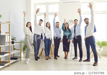 Group Portrait Of Happy Office Team Celebrating Success And Raising Hands Group Portrait Of Happy Office Team Celebrating Success And Raising Hands 127303766