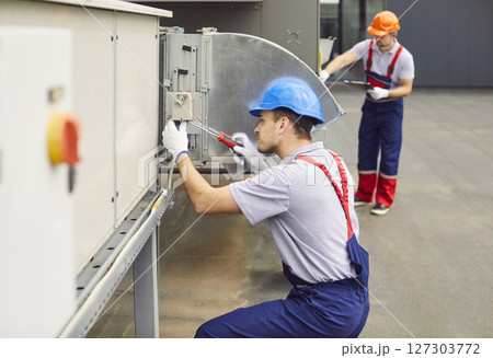 Repairman Conducting Inspection, Service, Or Repair Of Hvac System On Roof 127303772