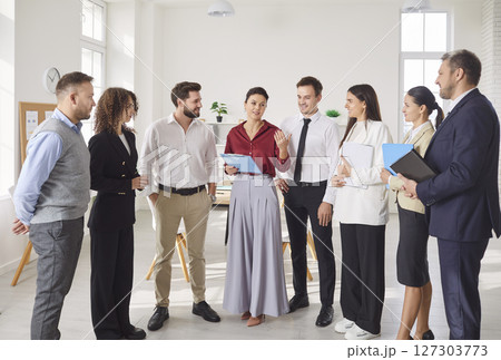 Business Team Engaging In Conversation During Office Presentation 127303773