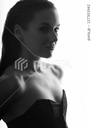 Beautiful woman with corset and wet hair studio portrait 127303942