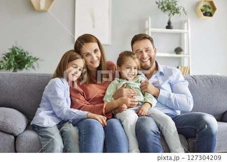 Happy Family With Children Embracing On The Couch At Home 127304209