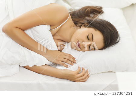 Satisfied Woman Sleeping In Bed At Home In The Early Morning Satisfied Woman Sleeping In Bed At Home In The Early Morning 127304251