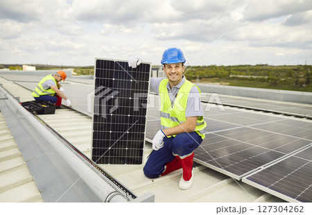 Service engineers are checking the solar cells on the roof for maintenance and installation. 127304262