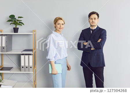 Portrait Of Happy Coworkers In Office Against Gray Wall 127304268