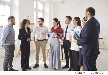 Business people group professional achievement, offering support, standing talking in modern office Business people group professional achievement, offering support, standing talking in modern office 127304272