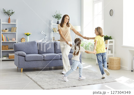 Mother, Son, And Daughter Dancing And Playing Together At Home Mother, Son, And Daughter Dancing And Playing Together At Home 127304349