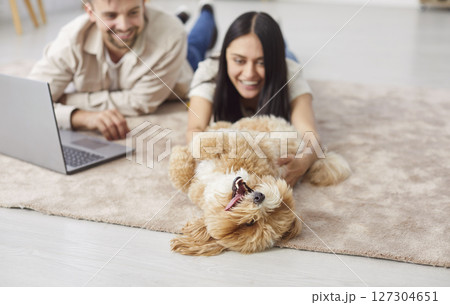 Family Couple Playing With Dog During Leisure Time At Home Family Couple Playing With Dog During Leisure Time At Home 127304651