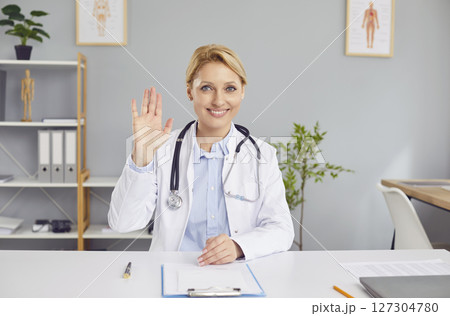 Doctor Or Nurse Waving During Online Video Call From Hospital Doctor Or Nurse Waving During Online Video Call From Hospital 127304780