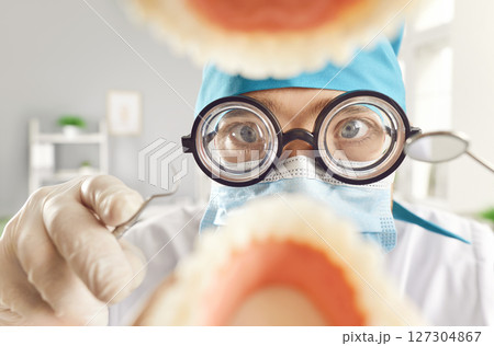 Funny Dentist Examining And Treating Patient Oral Cavity Funny Dentist Examining And Treating Patient Oral Cavity 127304867