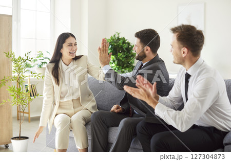 Group Of Business Coworkers High Fiving And Applauding In Office Meeting Group Of Business Coworkers High Fiving And Applauding In Office Meeting 127304873