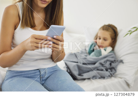 Young mother calling to pediatrician family doctor for her sick little child. Young mother calling to pediatrician family doctor for her sick little child. 127304879