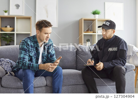 Male Crime Victim Giving Statement To Police Officer At Home 127304904