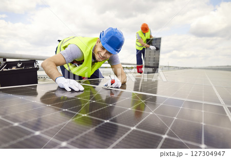 Electrician Repairing And Maintaining Solar Panels On Roof For Renewable Energy 127304947