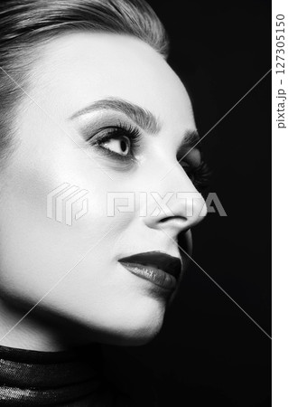 Close-up studio black and white portrait of woman with fancy make-up 127305150
