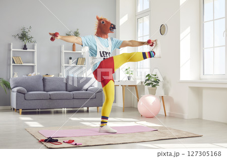 Funny Man In Retro Sportswear And Amusing Horse Mask Exercising At Home Funny Man In Retro Sportswear And Amusing Horse Mask Exercising At Home 127305168
