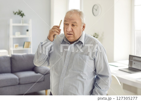 Retired old senior man, elderly person holding , using mobile phone to communicate Retired old senior man, elderly person holding , using mobile phone to communicate 127305277