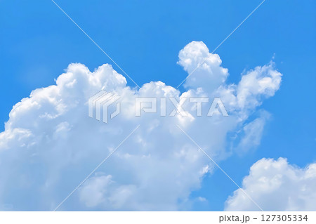 Fluffy White Clouds Against a Bright Blue Sky Atmospheric and Serene. 127305334