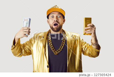 Surprised Man Holding Money And Gold Bar Surprised Man Holding Money And Gold Bar 127305424