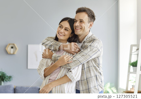 Portrait Of A Happy Family Couple Embracing At Home Portrait Of A Happy Family Couple Embracing At Home 127305521