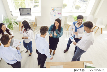 Group of young confident business people men and women talking in office during a meeting. 127305603