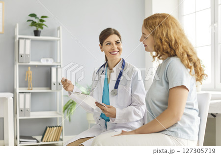 Happy attentive female therapist professional consulting woman client in office, female health 127305719